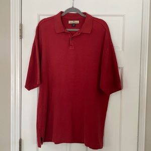 Men’s Tommy Bahama polo shirt in a red/rust color.